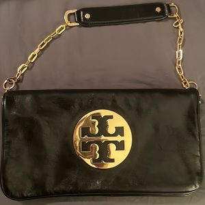 Tory Burch Reva Clutch. Glazed leather black and gold